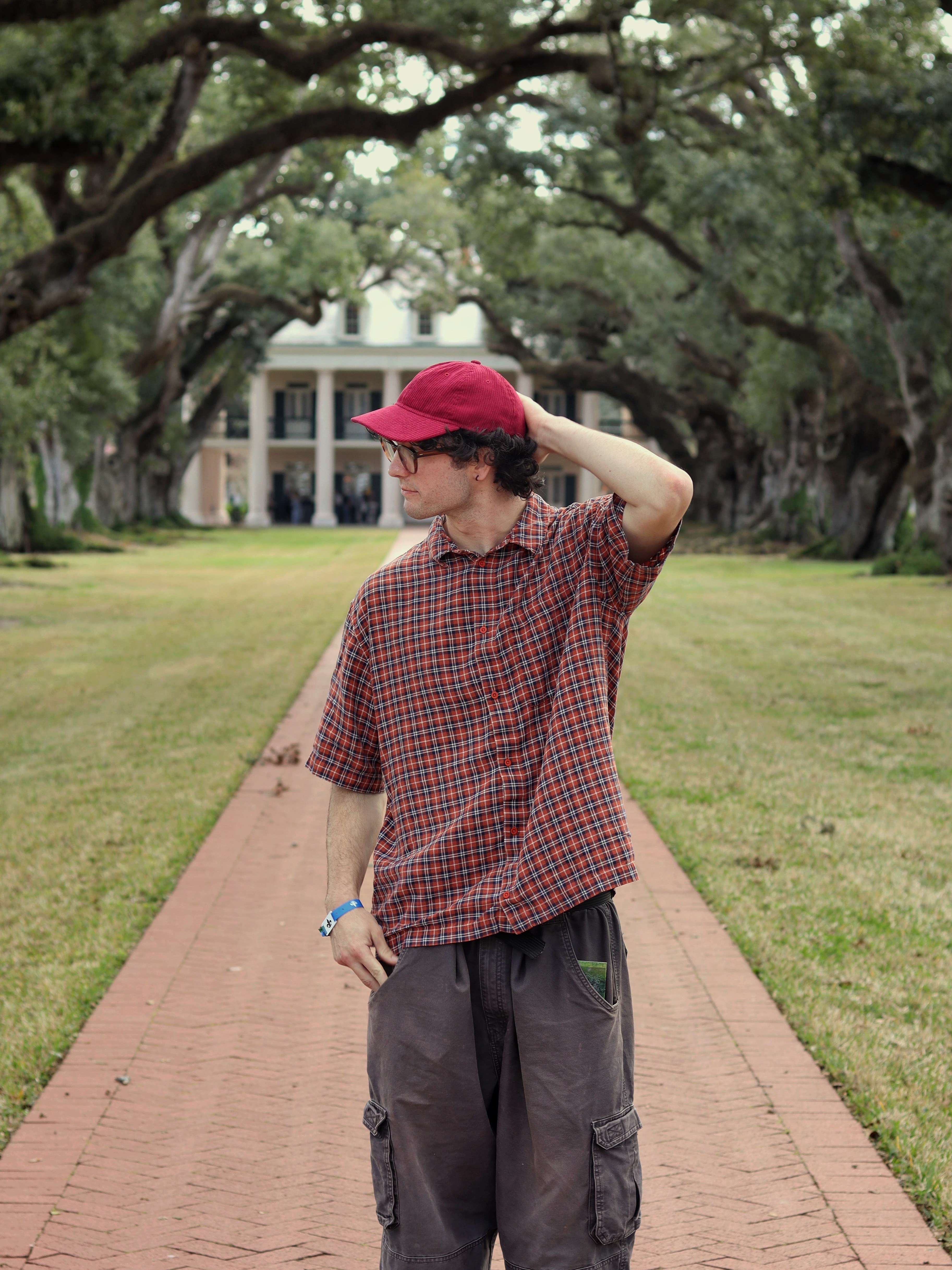 Man in red on tree lined road
